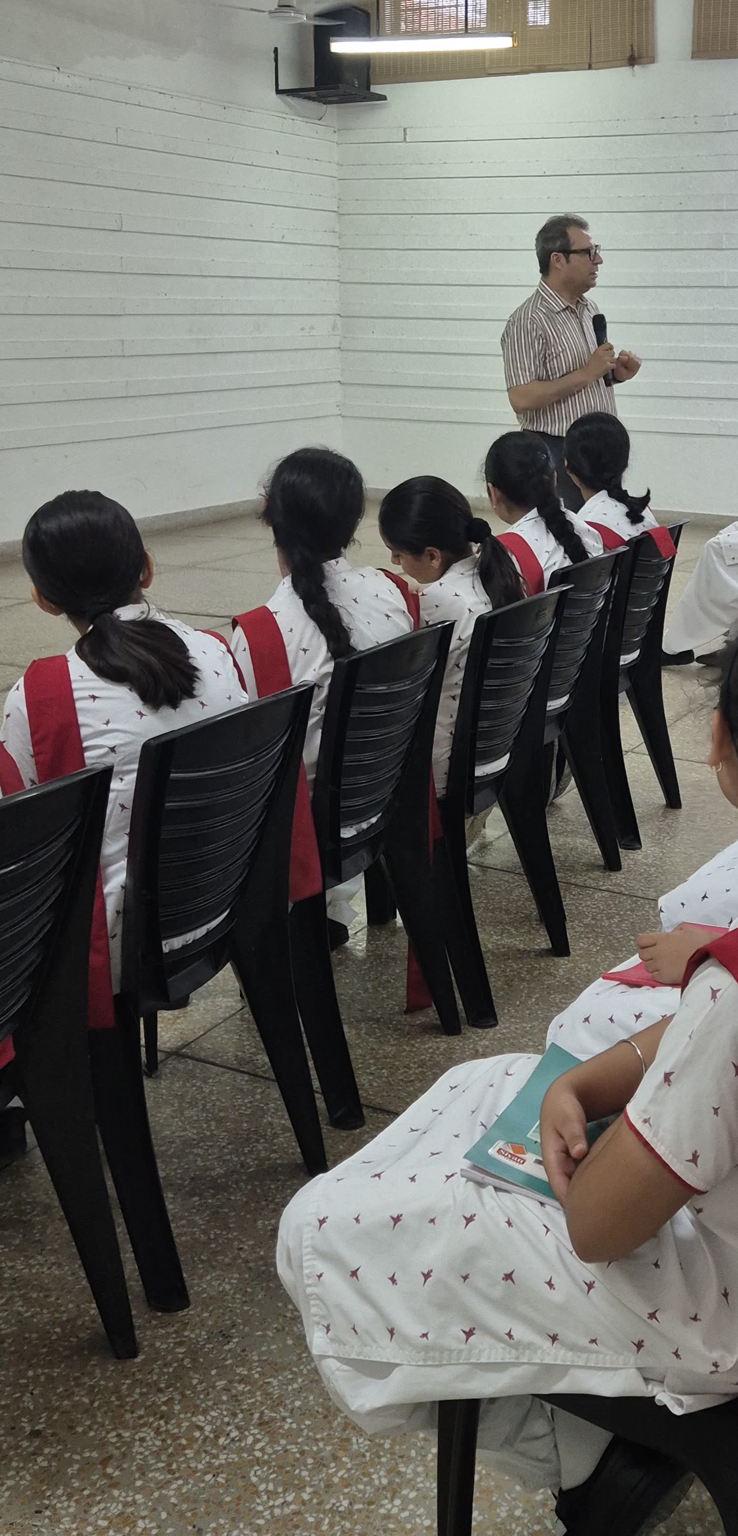 A Rosemounts facilitator speaking to Grade 6–8 students at Hopetown Girls’ School, photographed from behind the students