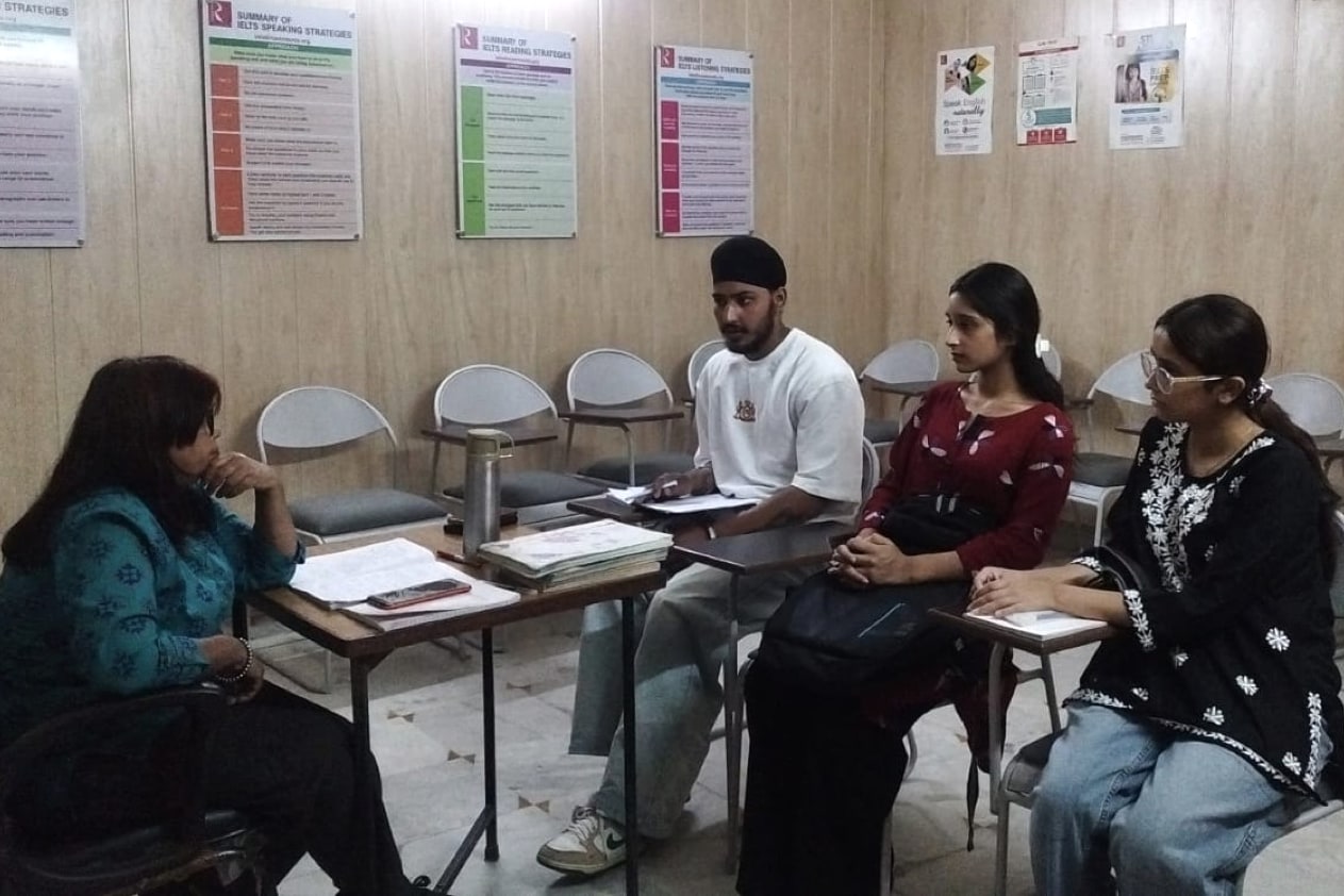 Adult learners taking part in a small-group English class at Rosemounts Institute in Dehradun